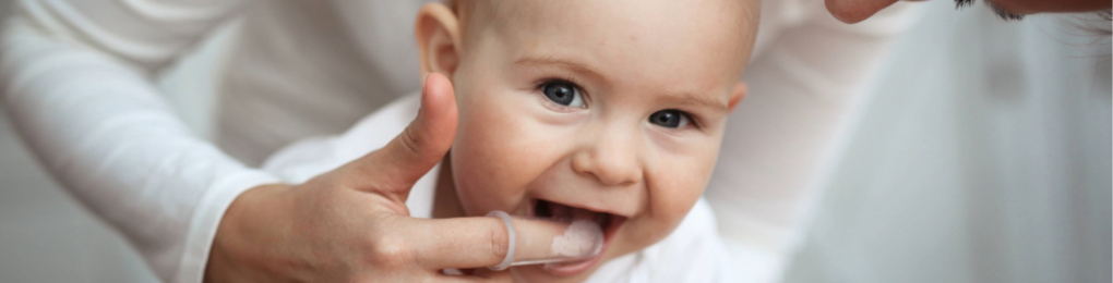 Mother caring for baby’s teeth.