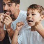 Dad and son flossing