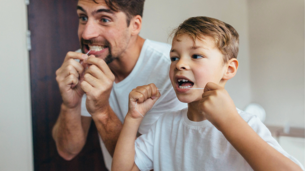 Dad and son flossing