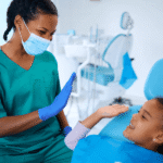 dentist and kid in dental chair high fiving