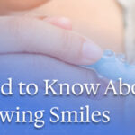 parent brushing baby’s teeth